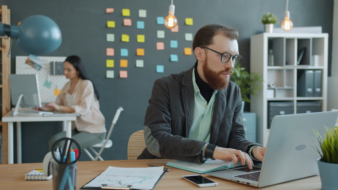 Man and woman working in modern office setting.