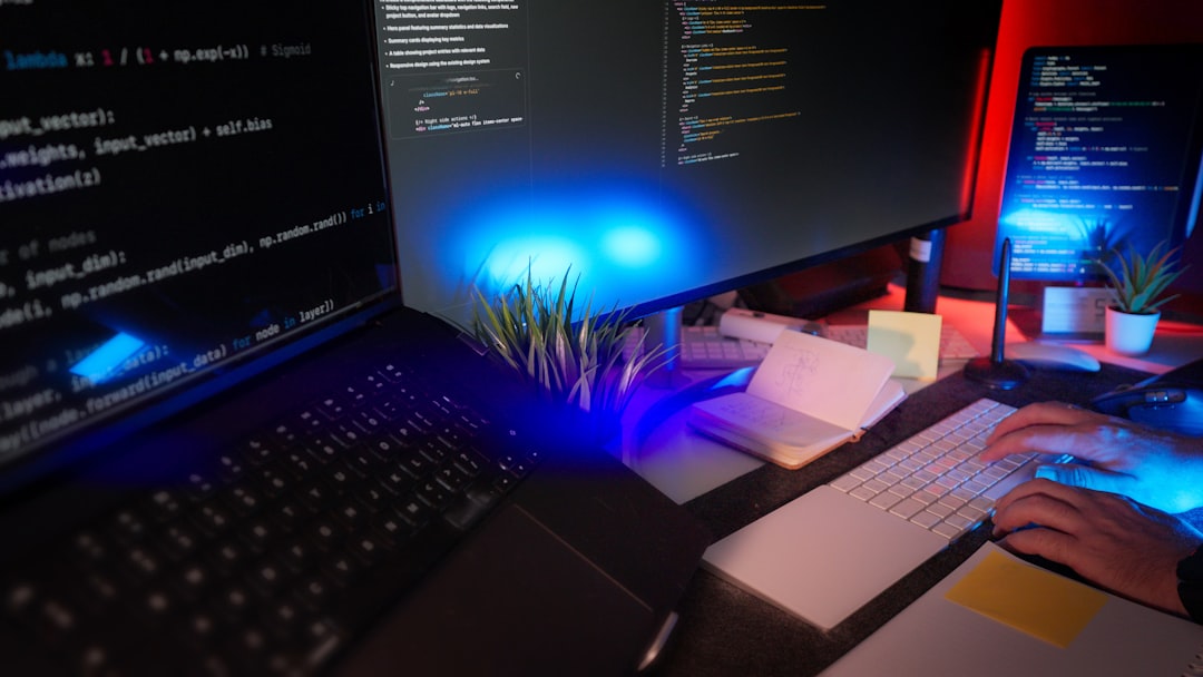 Programmer coding at a desk with several monitors.